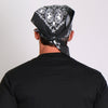 Black paisley skull bandana by Hot Leathers, featuring detailed paisley and skull design on soft fabric.