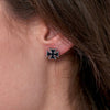 Hot Leathers Iron Cross Post Earrings, black metal accessories with vintage-style design, close-up of the jewelry worn on ears.