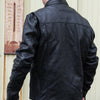 Milwaukee Leather men's black motorcycle leather jacket with scooter collar, shown from the back in a lifestyle setting.