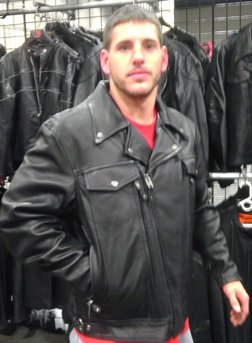 Men's high-end utility cruising leather jacket by DynamicLeather, featuring cargo pockets and sleek design, shown on a hanger.