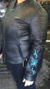 Teal leather biker jacket with butterfly embroidery and reflective details, HighwayLeather's stylish motorcycle jacket viewed from side.