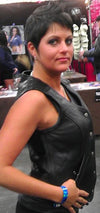 Side view of women's crop leather motorcycle vest by Dynamicleather, featuring a fitted design and metal zipper closure.