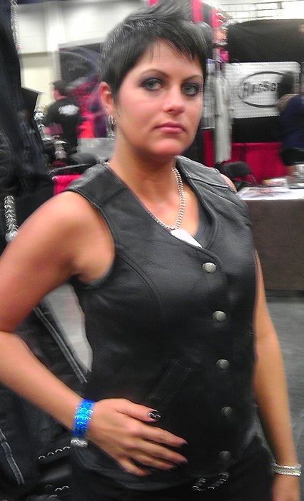Women's crop leather motorcycle vest by Dynamicleather, featuring a fitted design, front zipper, and classic motorcycle vest style.