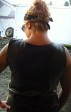 Back view of a woman wearing the black leather motorcycle vest.