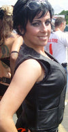 Black women's leather vest with side stretch panels and front snap closure, featuring a stylish and fitted design by Dynamicleather.
