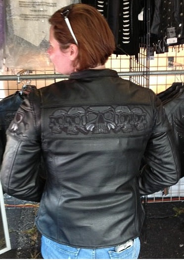 Back view of HighwayLeather women's sporty scooter jacket featuring reflective skull designs and a sleek, stylish motorcycle-inspired look.