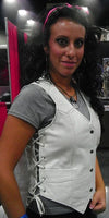 Women wearing a white leather vest with side strings from Dynamicleather, showcasing its stylish fit and design.